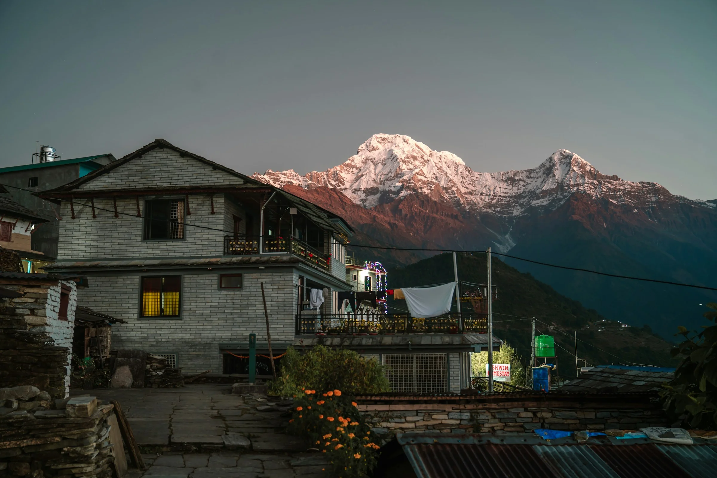 A house with mountains behind it in Nepal