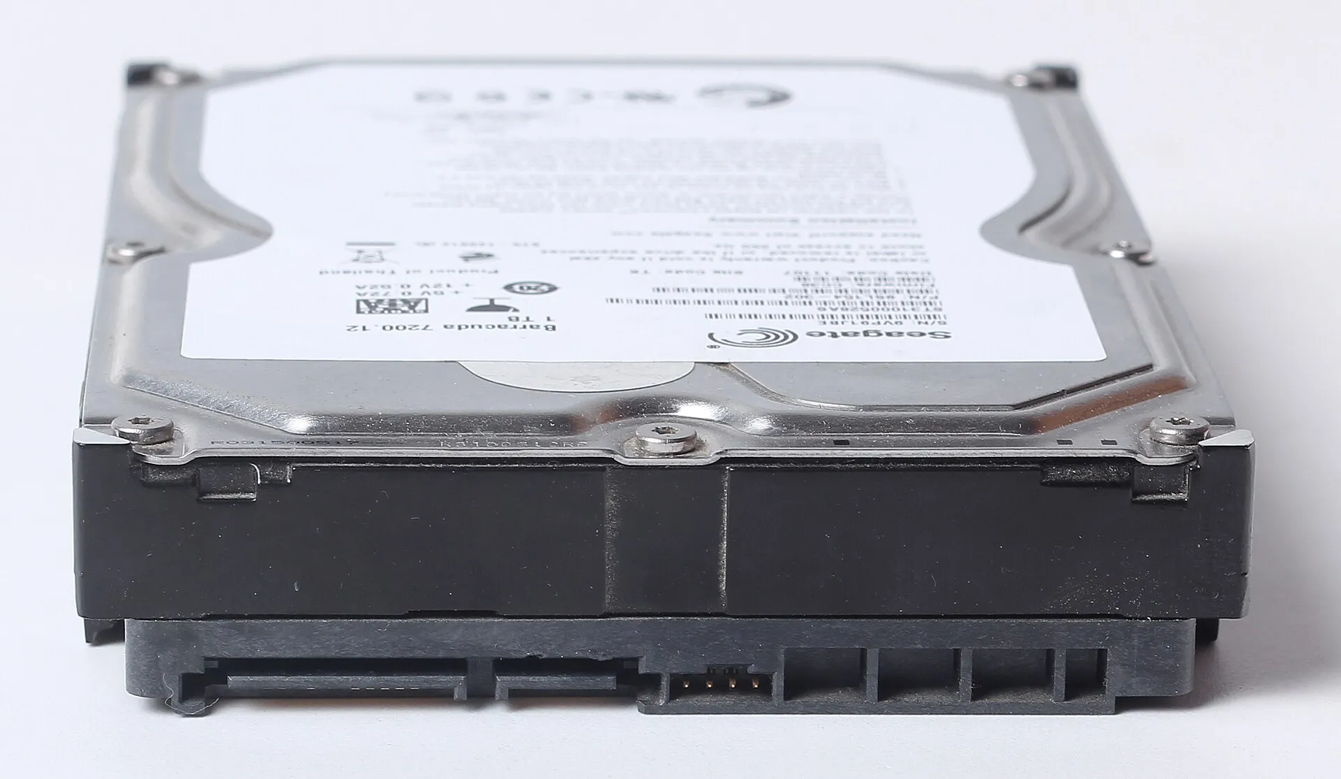 Seagate Barracuda 1 TB hard disk seen from the connector side with its label facing up